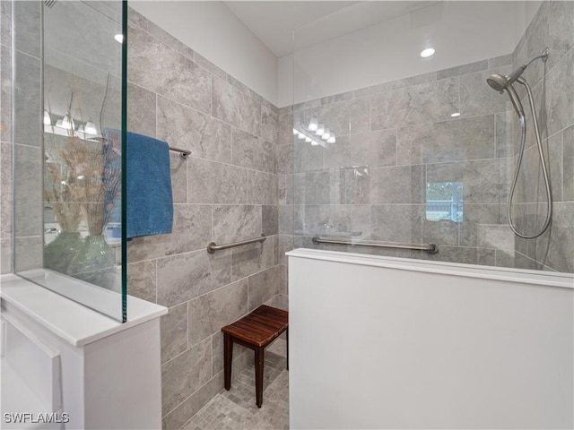 bathroom with tiled shower and tile walls