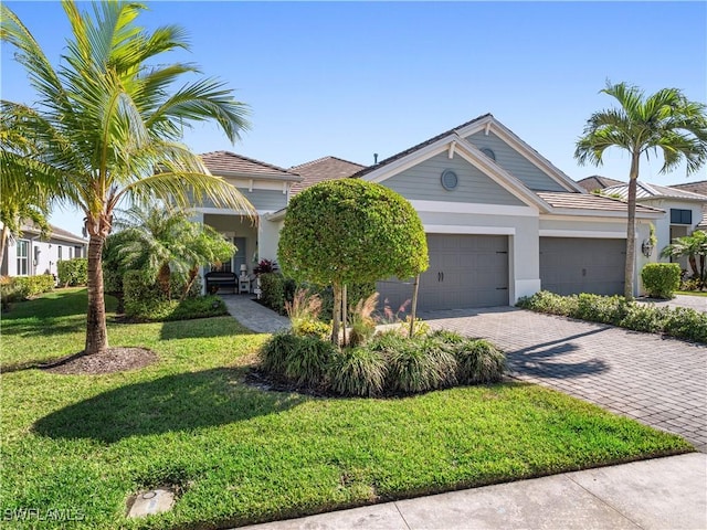 view of front facade with a garage and a front lawn