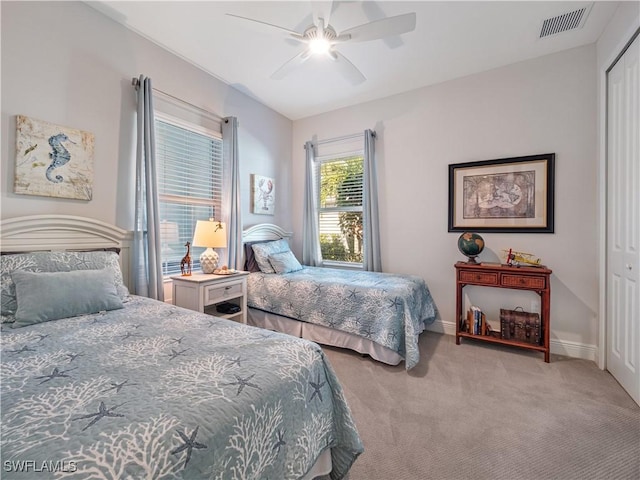 carpeted bedroom with a closet and ceiling fan