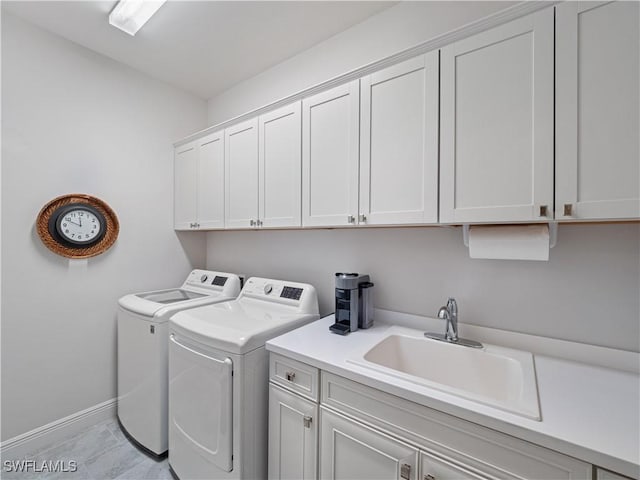 laundry room with sink, light tile patterned flooring, cabinets, and washing machine and clothes dryer