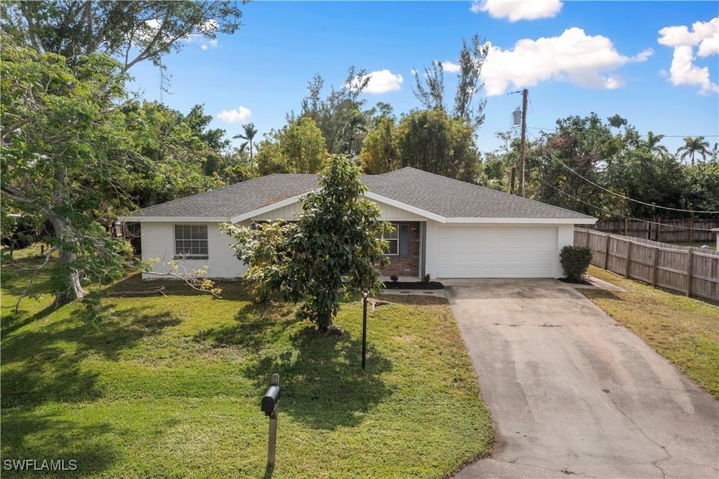 single story home with a front yard and a garage