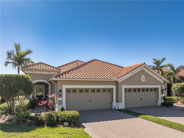 mediterranean / spanish house featuring a garage