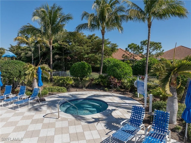 view of swimming pool with a patio area and a hot tub