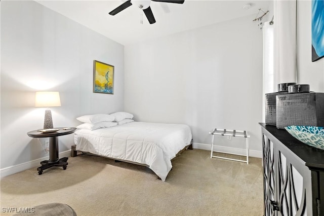 bedroom with ceiling fan and light carpet