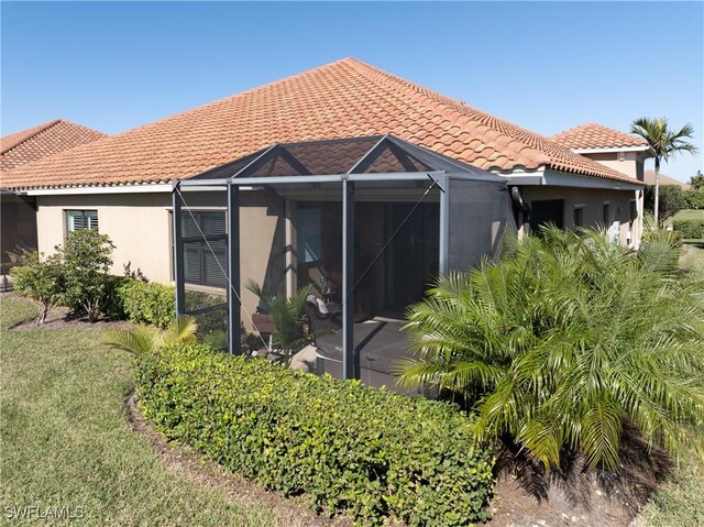 back of house featuring a lanai