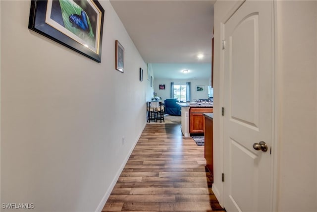 corridor with light hardwood / wood-style flooring