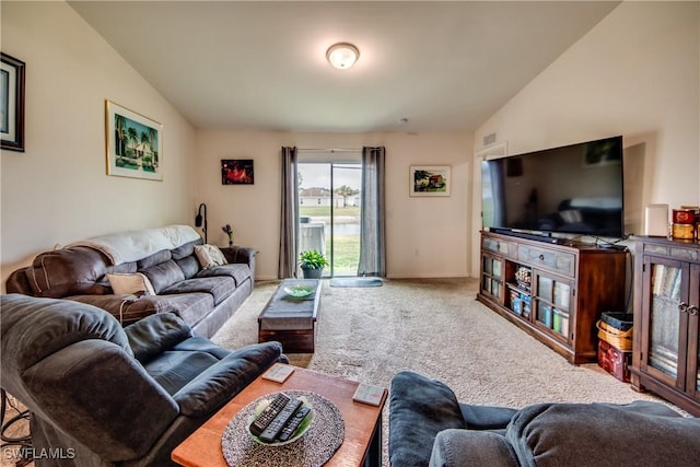 living room featuring lofted ceiling and carpet flooring