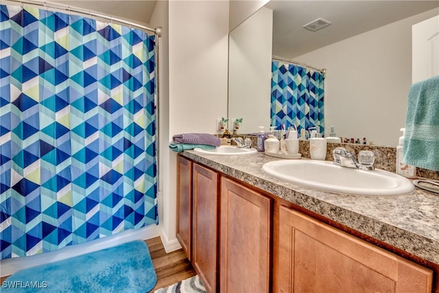 bathroom featuring vanity and hardwood / wood-style floors