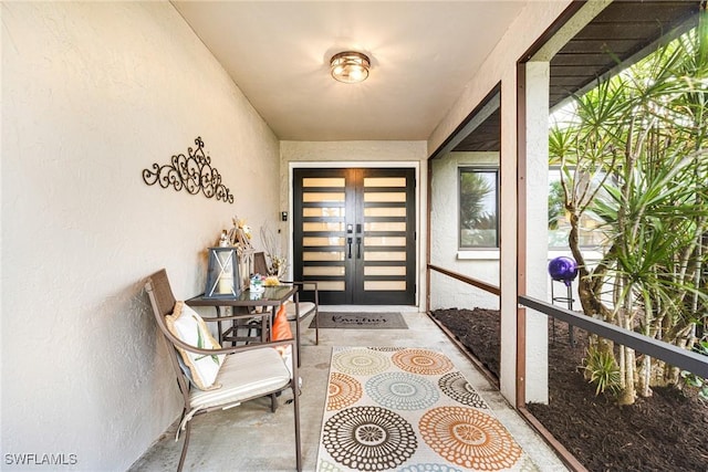 entrance to property with french doors and stucco siding