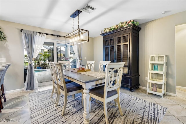 tiled dining area with an inviting chandelier