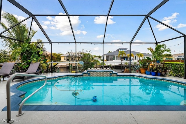 view of swimming pool featuring glass enclosure