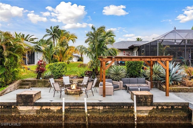 view of patio / terrace featuring glass enclosure and an outdoor living space with a fire pit