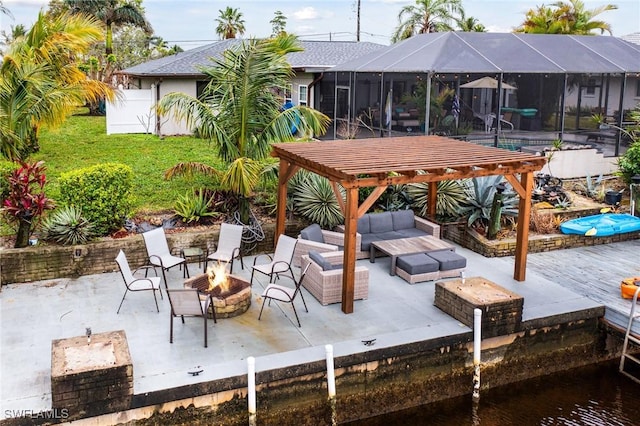 view of patio / terrace with glass enclosure and an outdoor living space with a fire pit