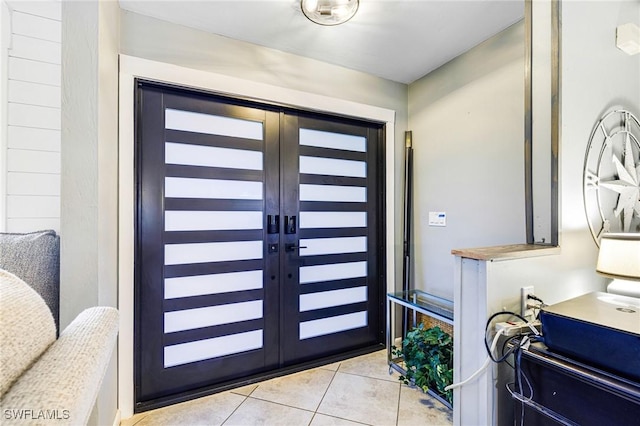 entrance foyer featuring french doors and light tile patterned flooring