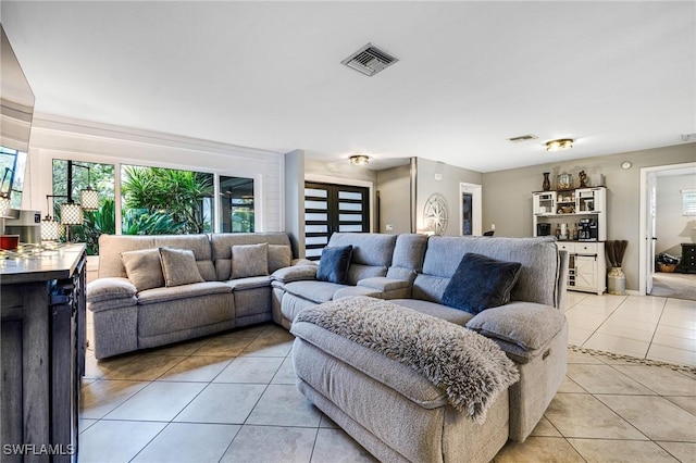 living area featuring visible vents and light tile patterned floors