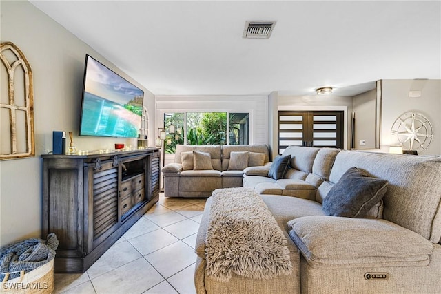 living area featuring light tile patterned flooring and visible vents