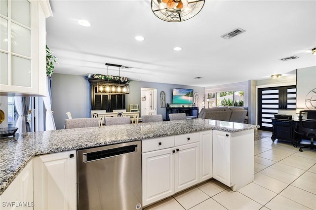 kitchen with visible vents, stainless steel dishwasher, glass insert cabinets, open floor plan, and white cabinetry