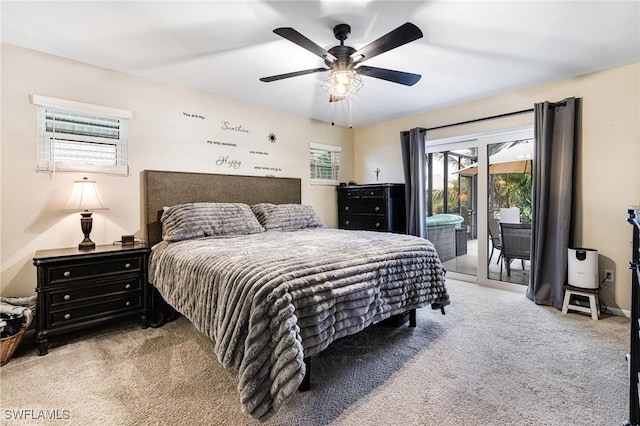 bedroom featuring light carpet, access to outside, and ceiling fan