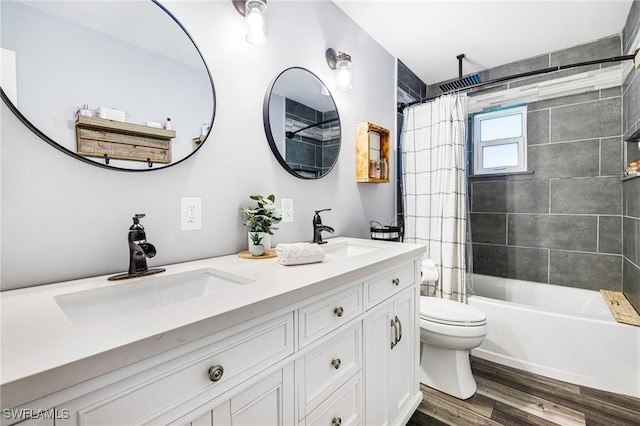 full bathroom with wood-type flooring, shower / bath combo with shower curtain, toilet, and vanity