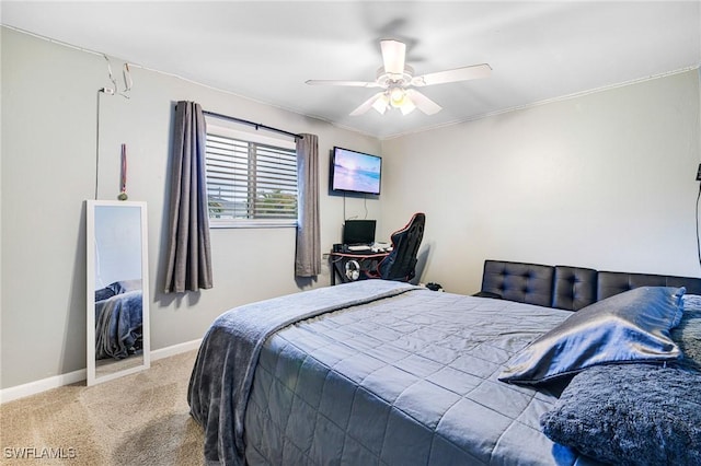 carpeted bedroom with a ceiling fan and baseboards