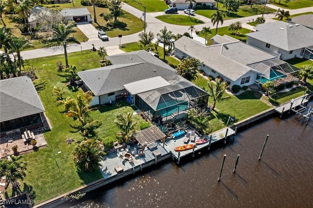 birds eye view of property with a water view and a residential view