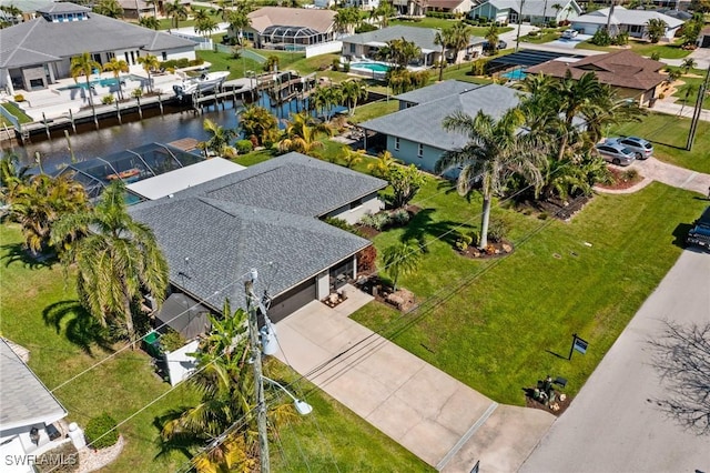 drone / aerial view with a water view and a residential view