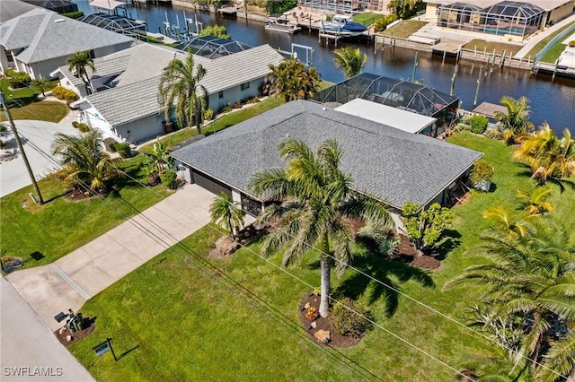 drone / aerial view featuring a residential view and a water view