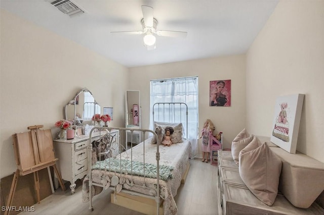 bedroom with ceiling fan and light wood-type flooring