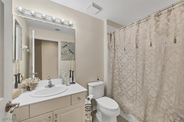 bathroom with toilet and vanity