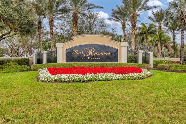 community sign featuring a lawn