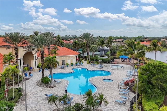 view of swimming pool with a community hot tub and a patio area