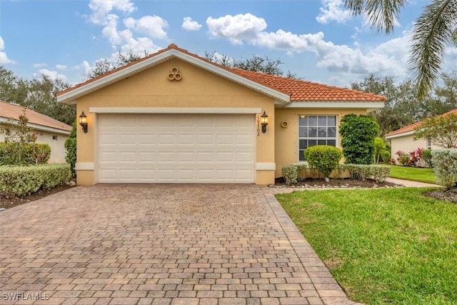 view of front facade with a garage and a front lawn