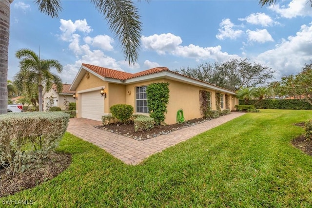 view of side of property with a yard and a garage