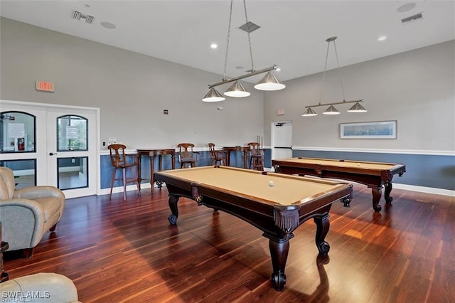 playroom featuring high vaulted ceiling, bar area, dark hardwood / wood-style floors, and pool table