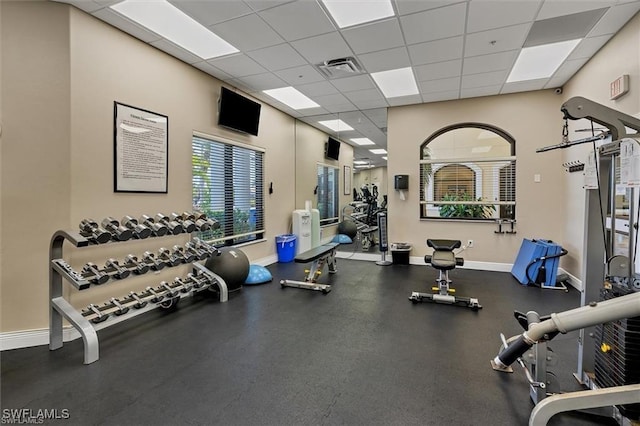 gym with a paneled ceiling