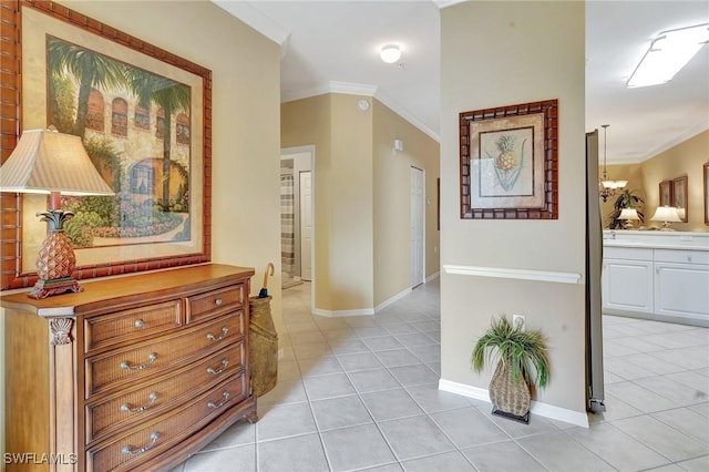 hallway with light tile patterned floors and ornamental molding