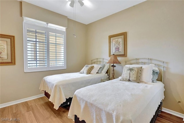 bedroom with hardwood / wood-style floors and ceiling fan