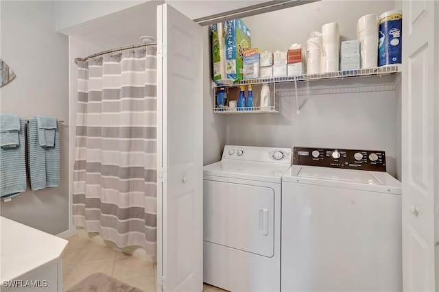 washroom with separate washer and dryer and light tile patterned flooring