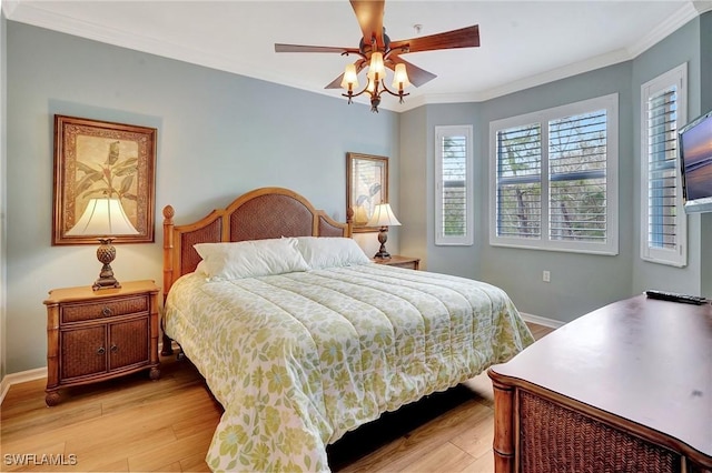 bedroom featuring ceiling fan, light hardwood / wood-style flooring, and ornamental molding