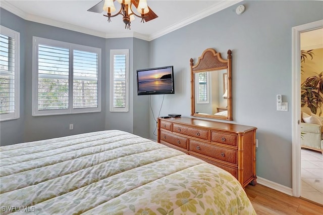 bedroom with crown molding, light hardwood / wood-style floors, and ceiling fan