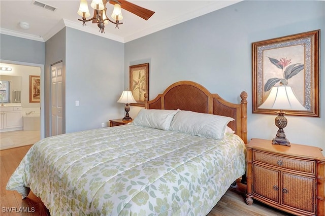 bedroom with ceiling fan, hardwood / wood-style flooring, ensuite bathroom, and ornamental molding