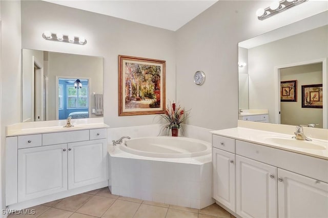 bathroom with vanity, ceiling fan, tile patterned floors, and tiled bath