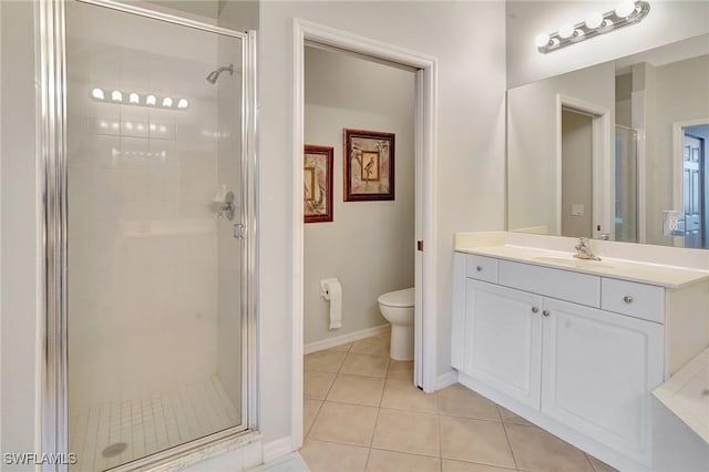 bathroom featuring a shower with door, toilet, tile patterned floors, and vanity