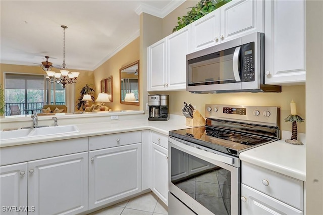 kitchen with sink, white cabinetry, appliances with stainless steel finishes, and light tile patterned flooring