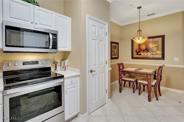 kitchen featuring pendant lighting, white cabinets, and stainless steel appliances