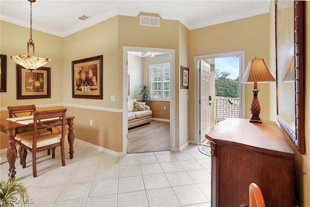 interior space with ornamental molding and light tile patterned floors