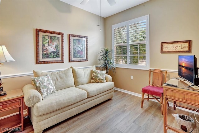 living room featuring light hardwood / wood-style flooring and ceiling fan