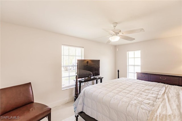 bedroom with multiple windows and ceiling fan