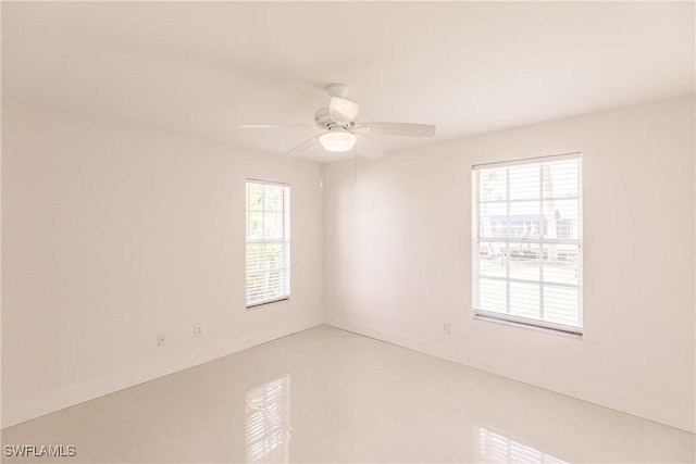 unfurnished room with ceiling fan and tile patterned flooring