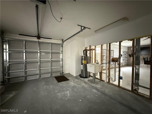 garage featuring sink and water heater